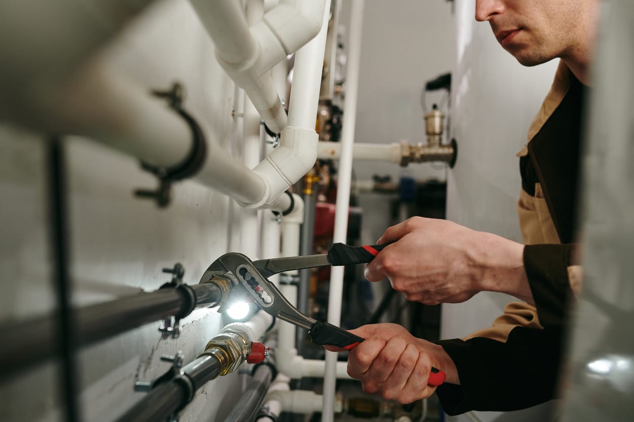 Plumbers maintaining commercial plumbing pipes in West Palm Beach