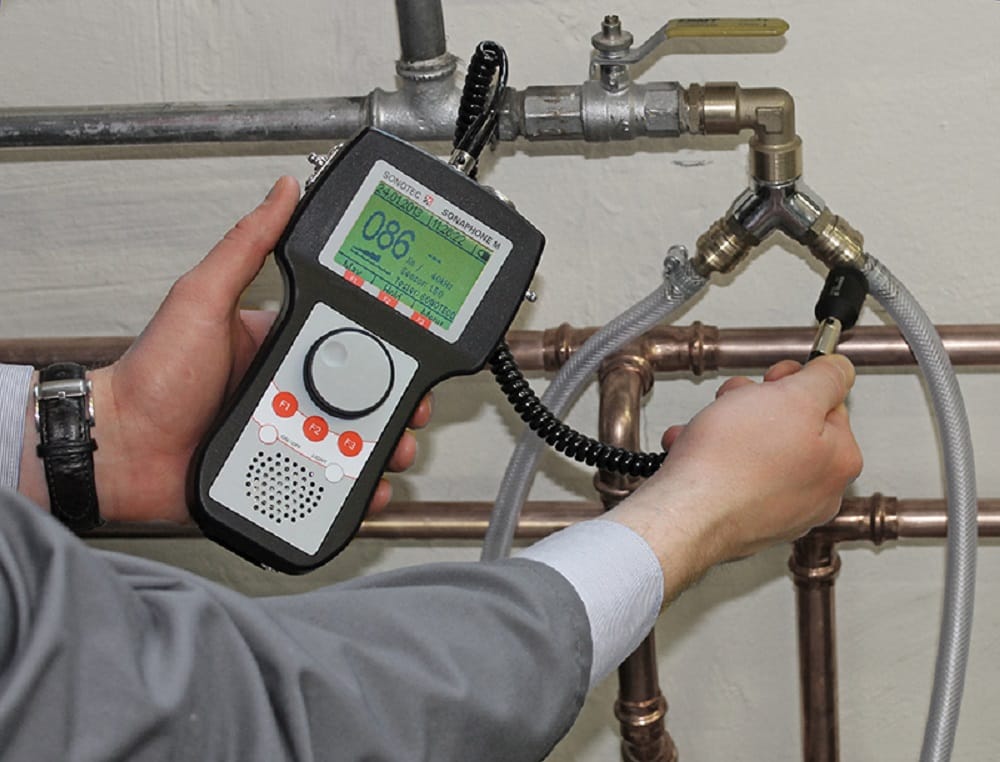 Plumber testing pipes with electronic leak detection equipment in West Palm Beach