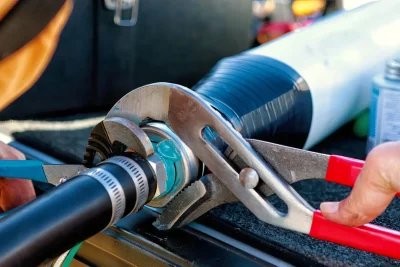 Technician tightening an industrial pipe connection in West Palm Beach