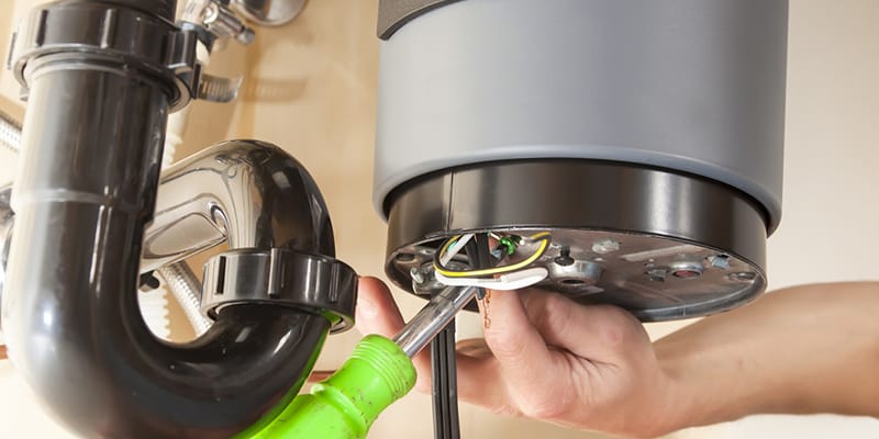 Technician repairing the heating element of a water heater in West Palm Beach